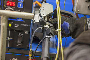 Image of welder checking MIG gun connection to the welding machine