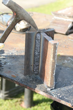 Image of a welder removing slag