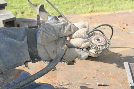 Image of a welder holding the front end of a MIG gun showing that the contact tip does not need to be changed