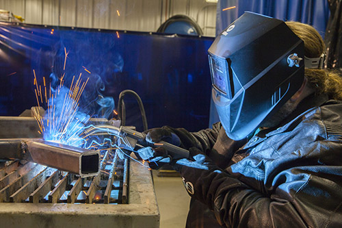 Image of a person welding while their MIG gun is overheating