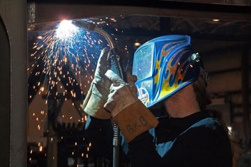 Image of a person welding in an overhead position