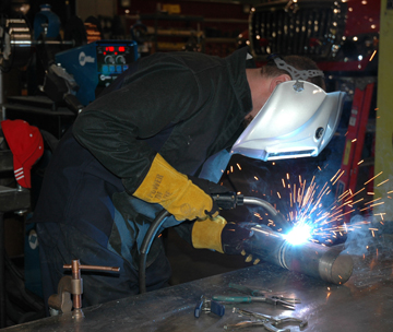 Image of a person welding in a welding shop