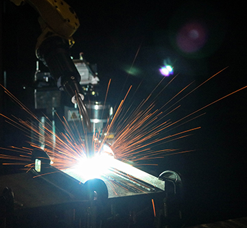 Image of a robotic welding application with sparks