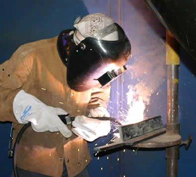 Image of a student Student practicing self-shielded flux-cored skills on sections of thick mild steel plate using the Dura-Flux gun.