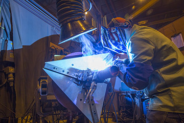 Image of  a welder on using a MIG gun