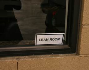 Image of a sign on a window labeled "LEAN ROOM".