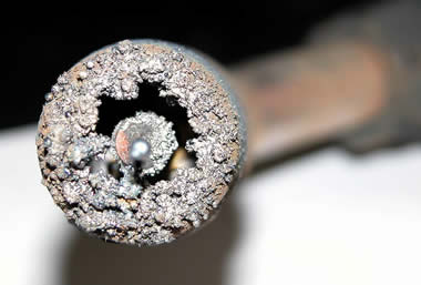 Tip of a nozzle caked with spatter